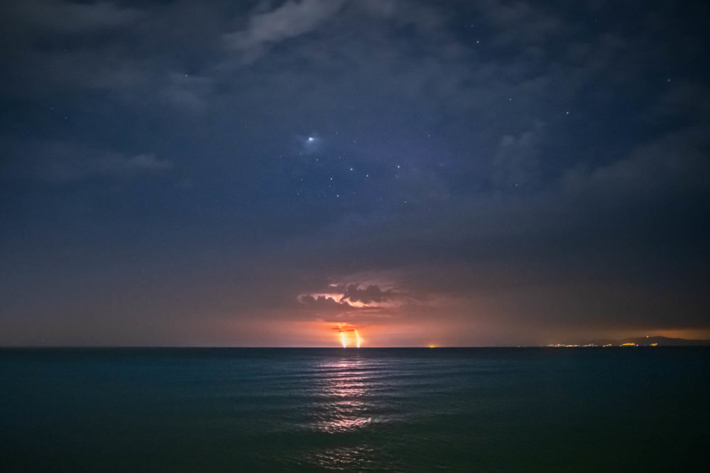 double lightning strikes into the sea at night